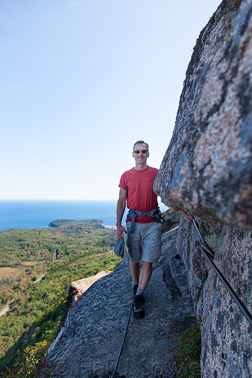 2011_09_21_AcadiaNP-10192-Edit750.jpg - Mike on the way down from the summit of Champlain.  Precipice Trail is much tougher going down than up!  In this shot there is a lethal drop a few feet to the right of where Mike is standing.  You want to use the handrail -- even if it is a bit loose.