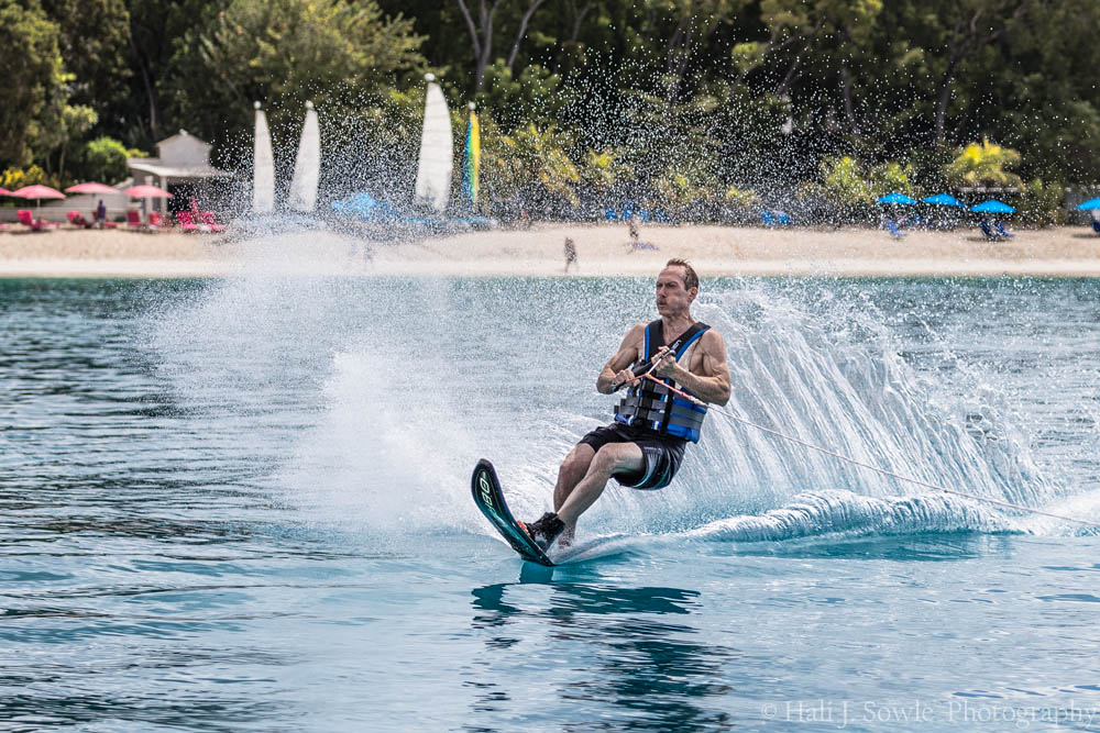 2016_11_Barbados-10092-Edit1000.jpg - Mike on water ski on the return, The resort in the background with the pink umbrellas is Sandy Lane Beach, part of the Sandy Lane Resort, a luxury destination in Barbados.  They have everything from private villas to suites on the ocean and 3 world famous golf courses.  It was a bit out of our comfort zone though.  We heard that off season rooms are $4,000.00 a night with a minimum 7 night stay.