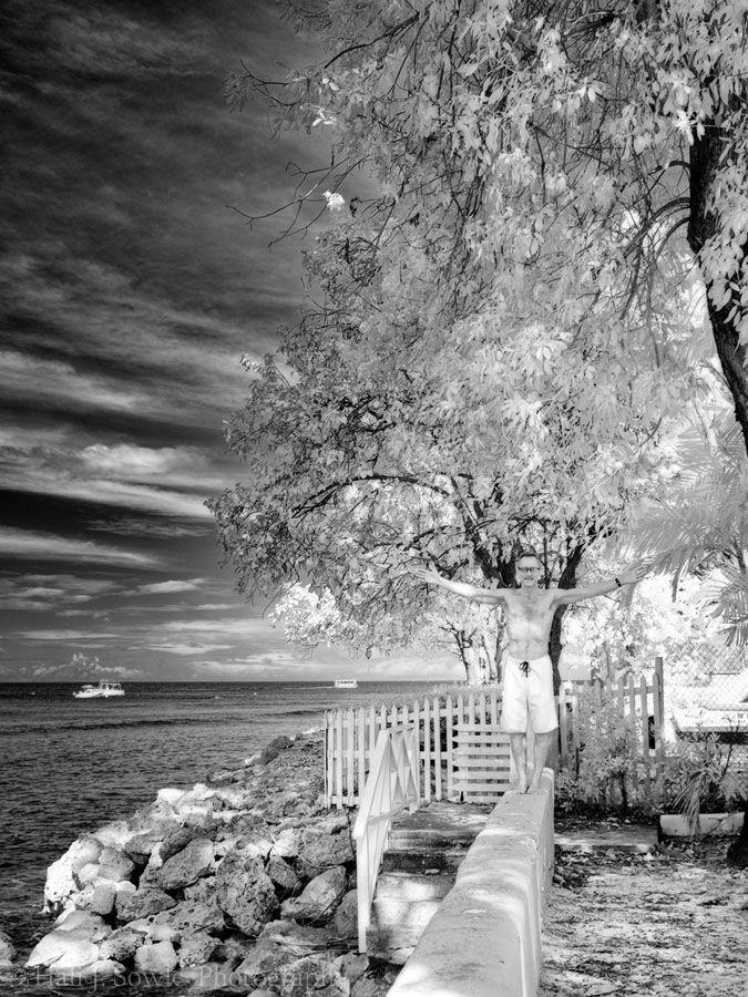 2016_11_Barbados-10630-Edit1000.jpg - Infrared shot of Mike on the wall along the path to the snorkeling spot.  You can see two snorkel boats out near the wreck.