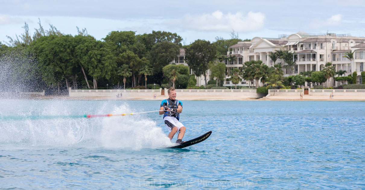 2016_11_Barbados-12095-Edit1000.jpg - Graham pulling hard with One Sandy Lane in the background.  One Sandy Lane is probably the most exclusive address on an Island that has many exclusive addresses and hosts celebrities like Rhianna, Mark Whalberg and Simon Cowell.  One Sandy Lane and the Sandy Lane resort were just a few minutes walk down from where we were staying at the club.  It could be a bit tricky getting there at high tide but once you got past the waves hitting up against the wall of the neighboring property it was smooth white sand beach for a good long walk.