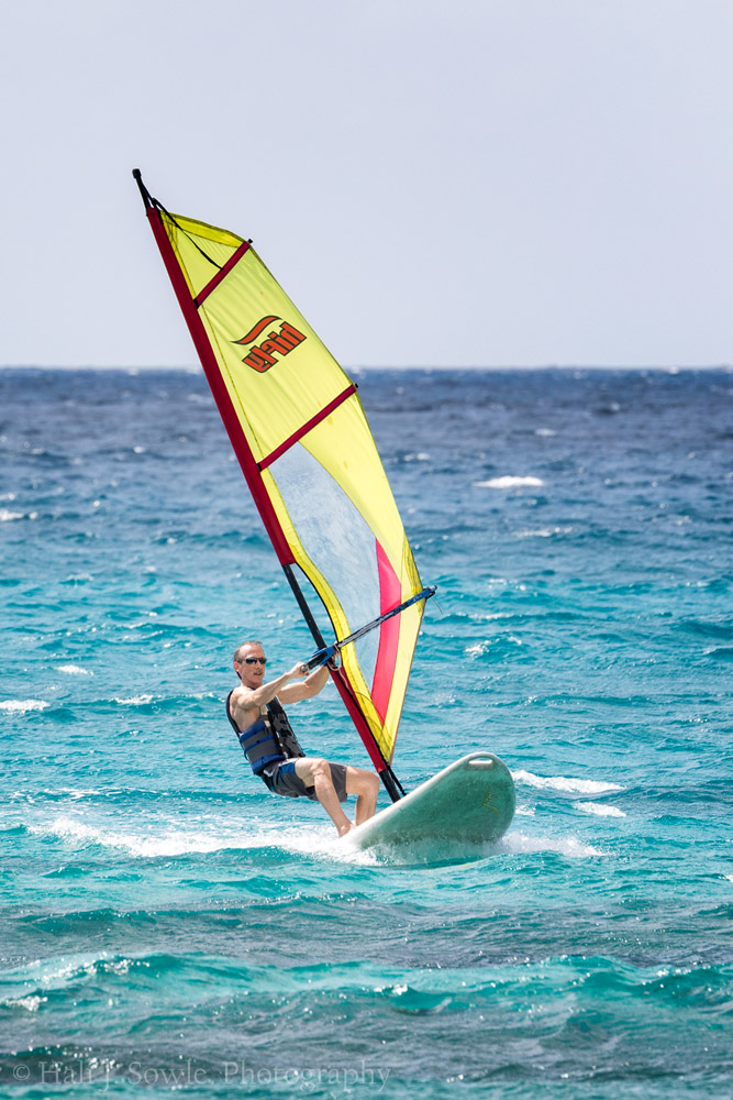 2016_11_Barbados-13250-Edit1000-2.jpg - My water loving husband having more fun on the water, this time under wind power.  Again the water sports were just great, a lot of the places we have been they wouldn't let you out because the wind was blowing pretty good, but Mike knows his stuff and the guys there knew it.  The board and sail weren't in the best shape, and he didn't have his harness but he sure did have fun.