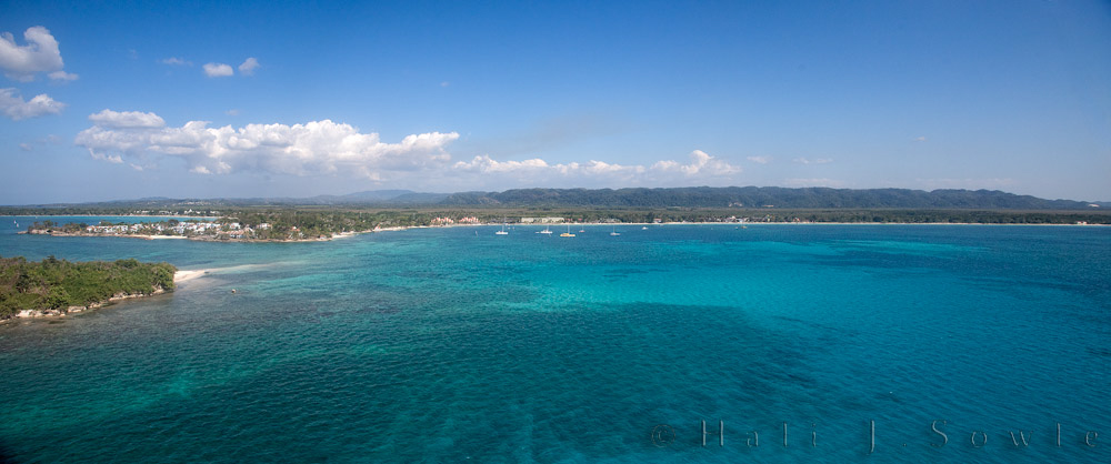 2011_01_21_BreezesGrand-10623-EditPano750.jpg - We went para-sailing for the first time when we were there and the view from above was wonderful!  You can see much of the seven mile beach and how incredibly clear the water was.  This is a Panoramic shot trying to show the 7 mile beach and the Sandals resort as well as the bay where Breezes Grand Resort resides.