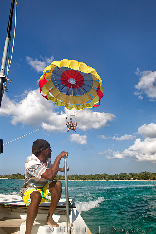 2011_01_21_BreezesGrand-10682-Edit750.jpg - Watching another couple come down from their turn high in the sky para-sailing.  The young man waiting to help unclip them was quite nice though I never once saw him smile.