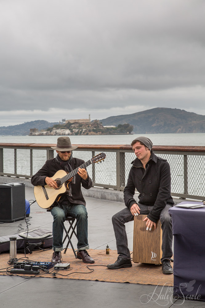 2015_05_California-10082-Edit1000.jpg - Keep the beat on the box you sit on.  It was a rainy day but that didn't stop the street muscians out on the Embacardo.  Alcatraz in the background.
