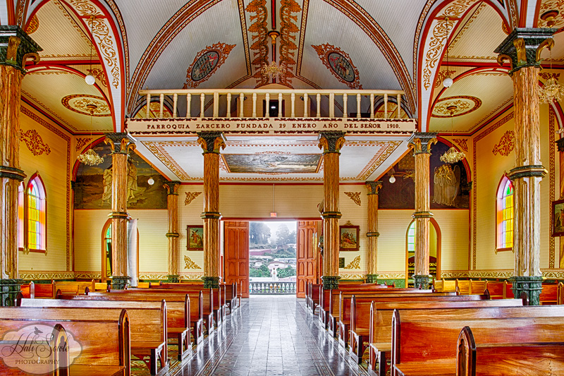 CostaRica_128.JPG - Inside the beautiful church of Zarcero with a view out to the town beyond the welcoming doors.