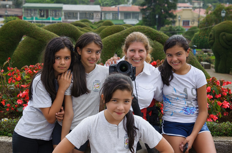 CostaRica_130.JPG - Hali making friends at the wonderful Parque Francisco Alvarado in Zarcero, Costa Rica. These school girls were really drawn to Hali. I think they were hoping to brush up on their English for the exam they had to take after their break.