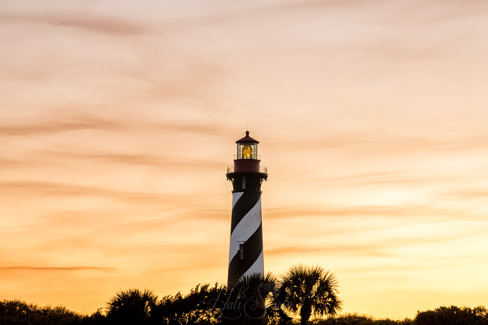 2015_02_Florida-10181-Edit1000.jpg - St. Augustine Lighthouse in the late twilight from the entrance to the pier.  There were a few people on the pier when we got there and we found out that there was supposed to be a Space-X rocket launch that night and the pier was a good place to watch.  Unfortunately for them it got scrubed, but good for us, because we got to see it actually go up when we went down to Titusville.
