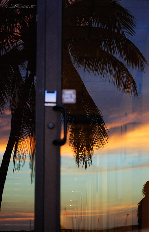 _JIM0164.jpg - Sunset from the back of the Hampton Inn on Key Largo, as reflected in the back entry door.  This was a very nice hotel that happened to be across the street from the most amazing seafood restaurant around (The Fish House).  They also had a great area to watch the sun set.