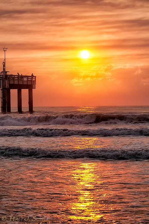 2011_06-12_StAugustine-10103-Web.jpg - The next to last morning we were in St. Augustine I got up to watch (and shoot) the sunrise but winds had shifted the wild fire smoke our way.  At first I thought it would be a total wash out but as the sun broke through the clouds and lit up the smoke it was beautiful.  The fisherman were on the St. Augustine Pier.  Fishing from the beach is free. To go on the pier you have to buy a pass.