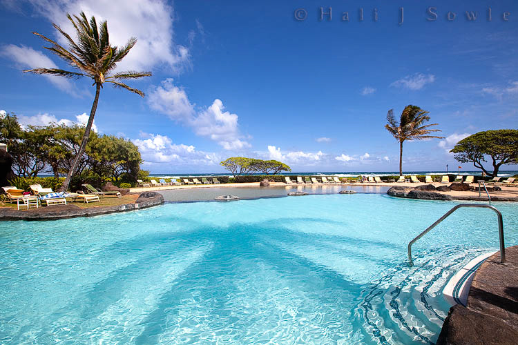 2009_10_01_Hawaii-10064.jpg - The slide pool at the Hilton Kaua'i.  There were two pools at the resort, this was the smaller of the two and featured a sand "beach" and a really fun water slide.  I loved the shadow of the palm tree in the pool.