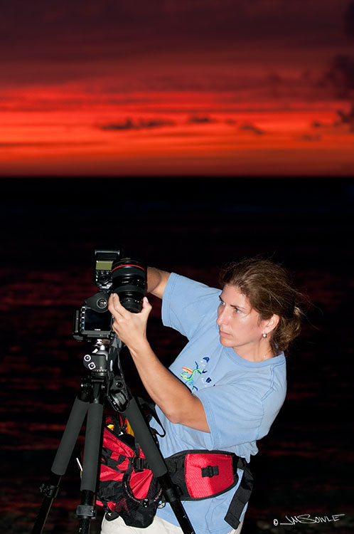 _MIK0122.jpg - Hali in action!  She loves to shoot sunrise and sunset.  Here she is during our very first night in Kaua'i at the beautiful Ke'e Beach.  The sun is already down, but she is swapping lenses to capture the brilliant "after glow".