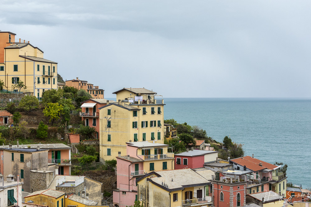 2017_09_15_Italy-10257-Edit1000.jpg - The brightly colored houses of the Cinque Terre show some wear but are still beautiful as they sit on the hillsides above the Mediterrean Sea.