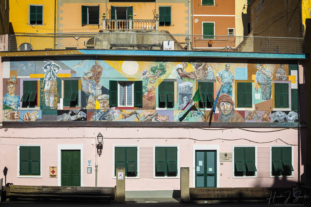 2017_09_20_Italy-10002-Edit1000.jpg - Early morning, city hall, Riomaggiore.  This mural tells the story of the men and women who fished the sea and picked the grapes of the region.  It was painted on the wall of the city hall of riomaggiore by the Argentinian artist Silvio Benedetto