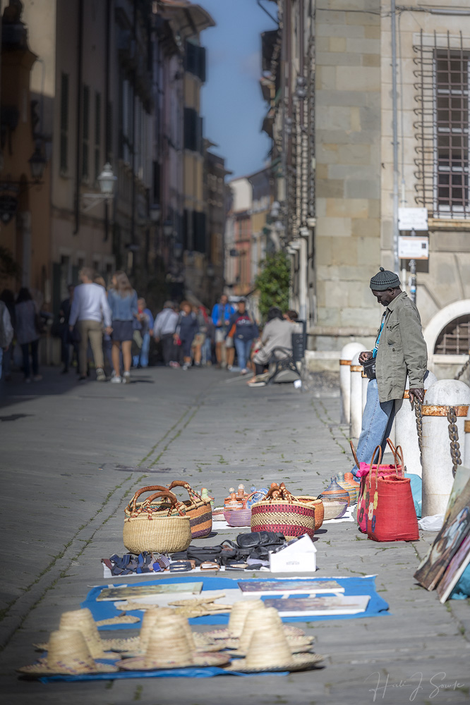 2017_09_21_Italy-10093-Edit1000.jpg - Street vendor Sarzana.  I think I've said before that I don't often take people pictures, it's not something I'm very comfortable with and what I experienced in Sarzana pretty much put me off of that forever.  After taking this photo I was screamed at by a well dressed woman pushing a baby carriage.  She obviously though I was taking a picture of her (I wasn't) but she made such a scene that other people started yelling at me too.  Probably the worst experience I have ever had anywhere with a camera.