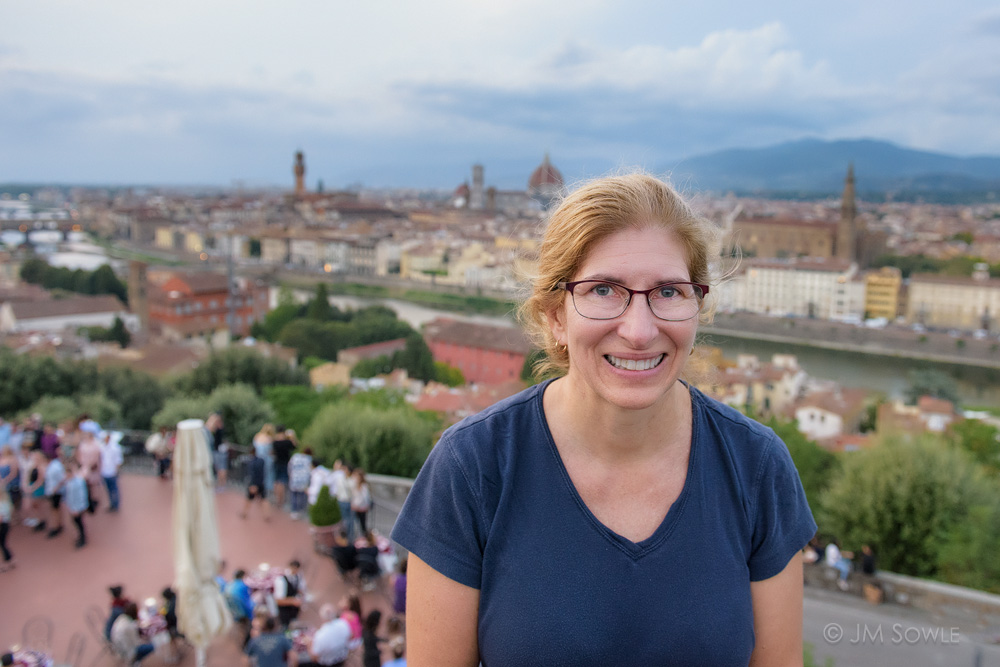 _JMS0121.jpg - Hali pausing for a photo op at the scenic Piazzale Michelangelo.  In the background you can see the river Arno, the Ponte Vecchio, and of course the Duomo.