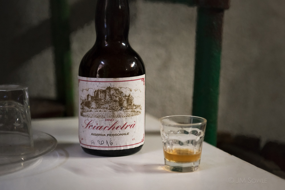 _JMS2471.jpg - Sciacchetrà is a sweet and strong dessert wine produced in the hills of Cinque Terre.  One morning we had breakfast at a tiny place in a hidden alley of Riomaggiore.  When we came out we noticed a small wine maker's shop across the way.  We met the wine maker and he was the nicest old guy.  He didn't speak English and we didn't speak Italian, but he offered us a small taste of his personal reserve.  Wow!