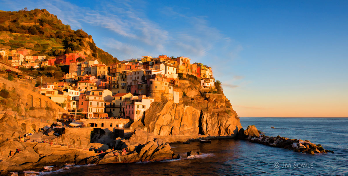 _JMS2717_Simple.jpg - Cinque Terre is probably most well known for the images of their harbors.  This is the harbor at Manarola.  At sunset the town lights up in a spectacular orange glow.  There are people lining the cliff to take pictures of this beautiful sight.  Many photographers say that it's the same shot taken by thousands of other tourists. Very true.  It's still beautiful.