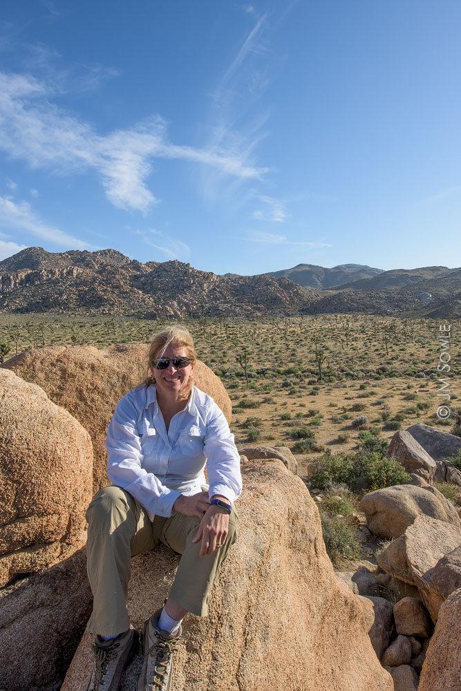 _JMS0279_2.jpg - Hali on a rock out cropping overlooking a forest of Joshua Trees.