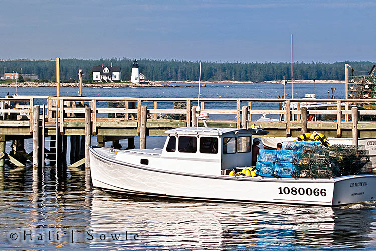 2009_06_30_Maine_-1085-Edit-Edit.jpg - Lobster boat and the Prospect harbor Lighthouse.  From near the Stinson Caning Company in Prospect Harbor.  The name of the boat is "Fat Bottom Girl", so Hali was singing "Fat Bottom Girls, you make this lobster world go round"...