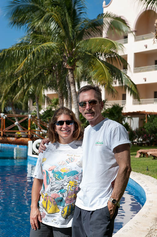 _JIM0456_.jpg - We didn't take any shots of ourselves this trip, but a friend from the pool took this shot for us.  This was just after breakfast, and we hadn't put on our swim suits yet.  This quiet area is where we spent a lot of time.  Note the bridge in the background to allow people to cross the pool/mote.