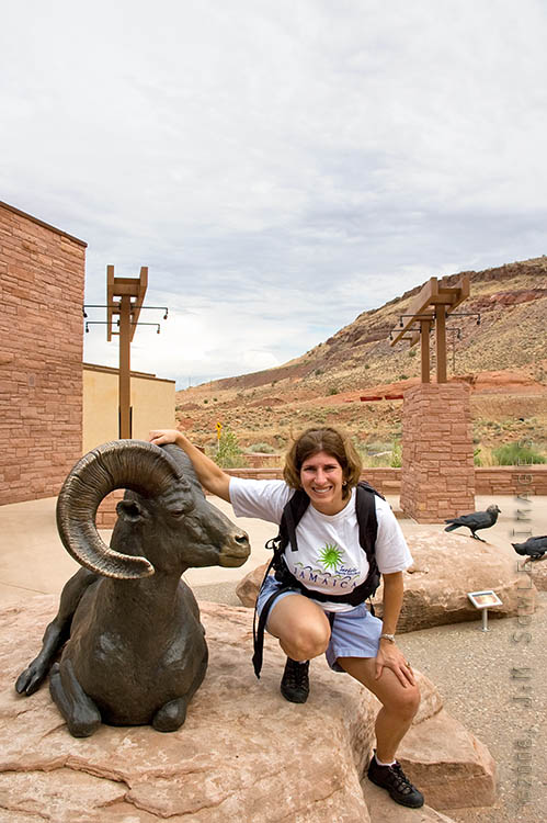 _DSC0010.jpg - The Arches National Park visitor center is pretty nice.  Here, Hali is posing next to one of the bronze statues outside the main entrance.