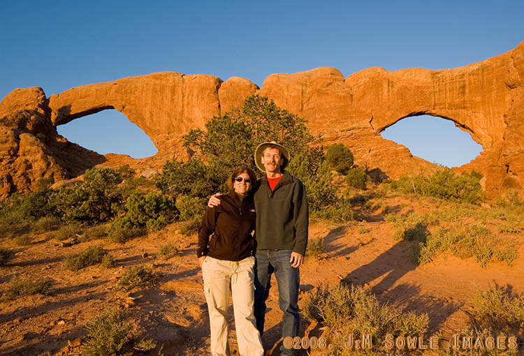 _DSC0755P2.jpg - Us at sunrise in front of the Windows Arches. The rocks get that really saturated color, but it only lasts for a few minutes after sunrise!