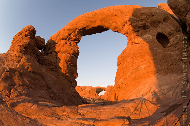 _DSC0814.jpg - This is Turret Arch at sunset, with the North Window Arch visible in the distance. As you can see from the multiple tripod shadows, this is not a lonely place at sunset.