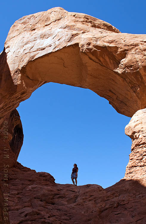 _JMS1125.jpg - Hali is taking in the impressive view of the second arch at Double Arch.  It doesn't look like it from this perspective, but she's standing on a narrow ledge with a 50 foot drop off right behind her.