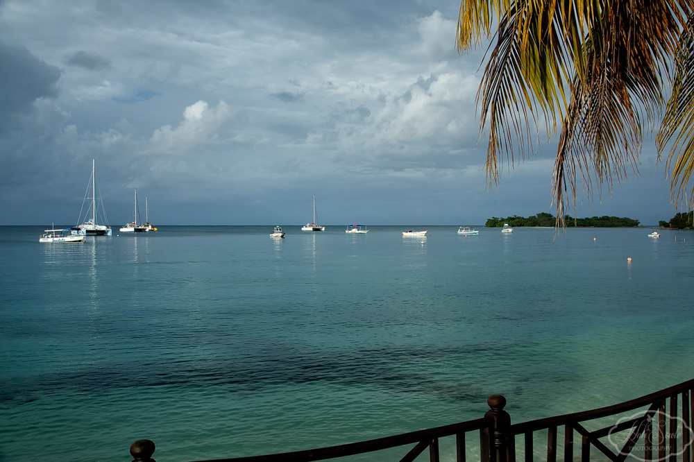 2014_01_SandalsNegril-10762-Edit1000.jpg - Sunlight on the water.  The view from where we had breakfast every morning.  The clouds were just starting to build up from the storm front that came through the last few days of our trip.