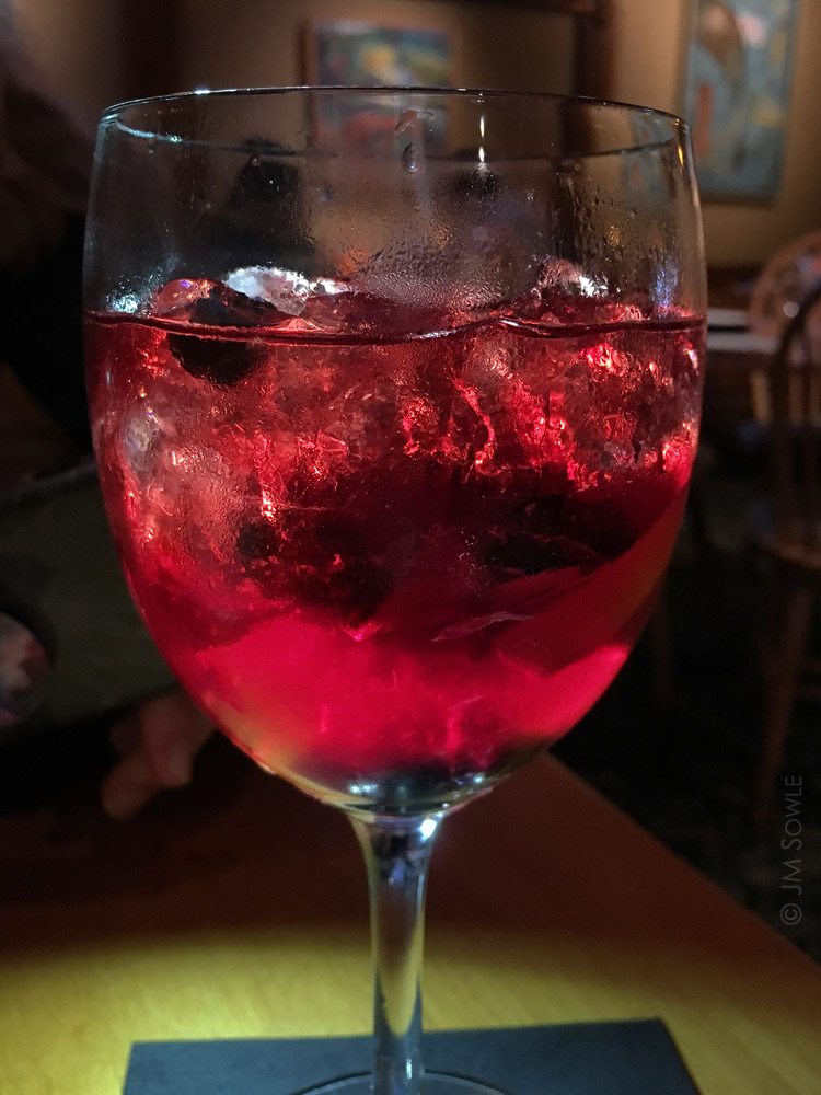 IMG_6236A.jpg - Our first night in Bar Harbor found us drinking delightful Blueberry Sangria in a popular downtown restaurant.  Hali was using her phone to provide lighting while I used mine to take the picture.