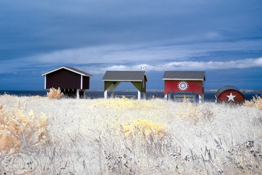 NovaScotia_45.JPG - On our way from Digby to Shelburne we stopped at a few lighthouses, although it isn't in this picture there is an old, rundown, non-working lighthouse to the right.  The lighthouse is on the grounds of the UnivesitÃ© Sainte-Anne which was founded in 1891 by french priests and is the only French university in Nova Scotia.  I believe these buildings are part of the university as they were very ell maintained.