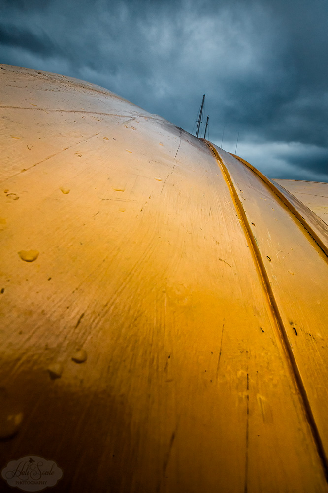 NovaScotia_76.JPG - It's all in how you look at it.  Masts of sailing ships over the hull of a Dory in Lunnenburg harbor.