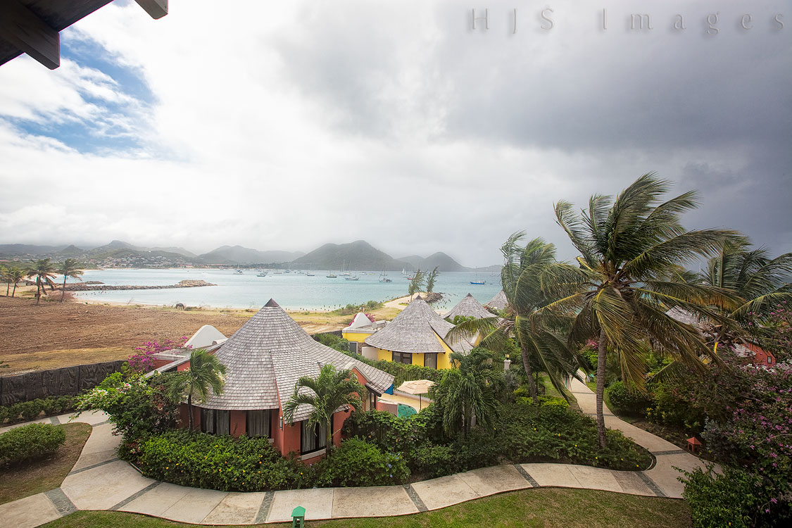 2010_01_17_SandalsGrandeStLucian-10362-EditWeb.jpg - This is the view from our second room.  It was not quite as beautiful as the view from our first room, but it was still pretty.  Wednesday was an on and off rainy day with periods of torrential rain and strong winds and then bright sunshine.   You can see the blue sky peeking through the clouds as the last of the rain of the morning blew through.