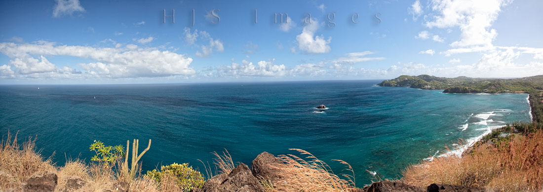 2010_01_18_SandalsGrandeStLucian-10079-Edit-web.jpg - A panoramic view of the Caribbean sea to the east of the resort.  The resort is built on a causeway made from the debris of the excavation of Rodney Bay in the 1970's, this view is from the top of "Signal Hill"  Where the British would keep an eye on the French Navy in Martinique (on the horizon to the left of those two large rocks).