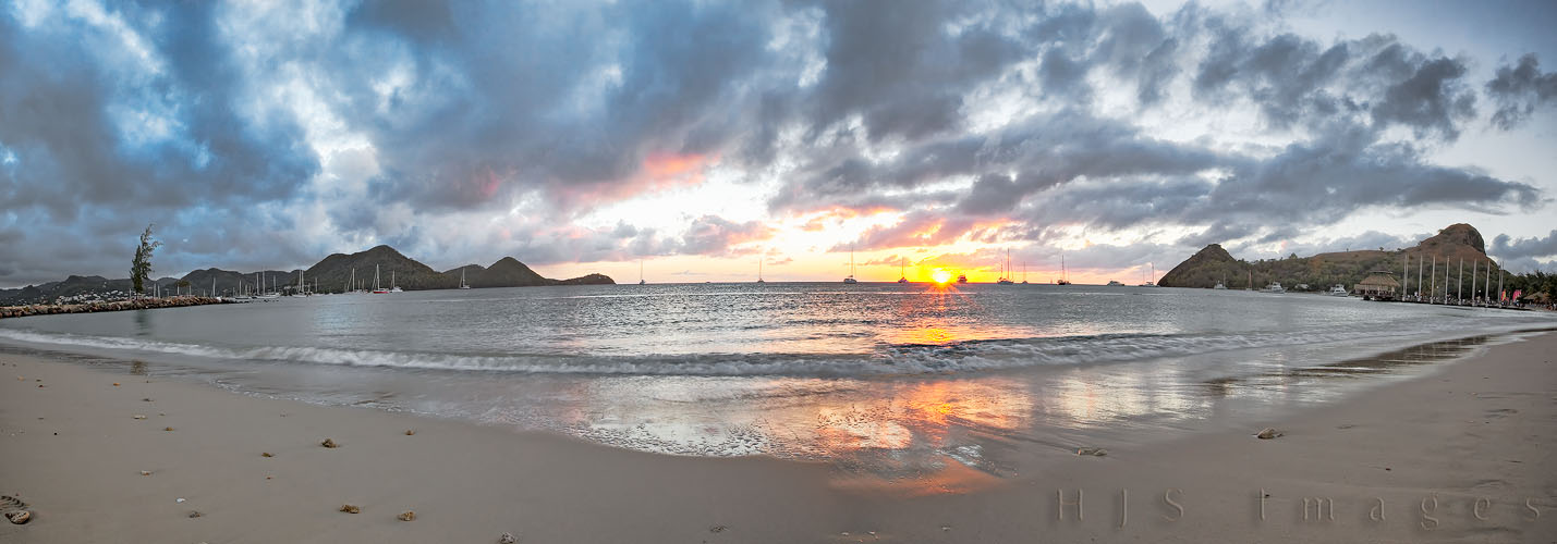 2010_01_18_SandalsGrandeStLucian_PanoWeb.jpg - This is a panoramic view of Rodney Bay, Gros Islet, St. Lucia.Rodney Bay is home to some of the most exquisite boats I have ever seen, Catamarans and Monohulls, at least one huge Yacht we saw goes back and forth across the Atlantic at least 2 twice a year, in under 26 days, on sail power. It was lots of fun sailing the little Hobie Waves in the bay but it could be a little nerve wracking with all the large boats around (for which reason most of the cleats were disabled on the Hobies preventing you from sailing close to the wind and potentially flipping the Hobie into a multi-million dollar yacht, thankfully we brought our sailing gloves and muscles so we hauled sail anyhow)