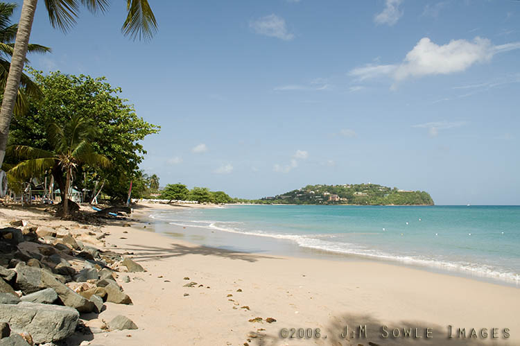 _DSC0425.jpg - This is a view down the beach.  The resort ends just after the Hobie sail, but the rest of the beach is wonderful for walks.  The beach is all public and busy with locals on Sundays and holidays (very quiet most other days). Just past the resort is Choc Cemetry -- a quiet neighbor.  On the other side of the cemetery is the local airport.  Many reviews complained about fly-overs, but we found the handful of daytime flights to be no bother at all.