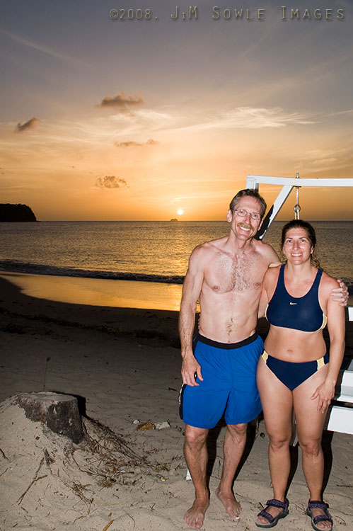 _DSC0463.jpg - It had been another fun day for us, and we found ourselves playing really fun games of volleyball until nearly sunset.  After the games ended, we realized that we might have a good sunset.  So we ran up to grab our cameras, but we didn't have time to shower and change.  This was one of the nicer sunsets during our stay.  We're standing in front of the swinging love seat, and you can see a cruise ship on the horizon -- they sail out of Port Castries.