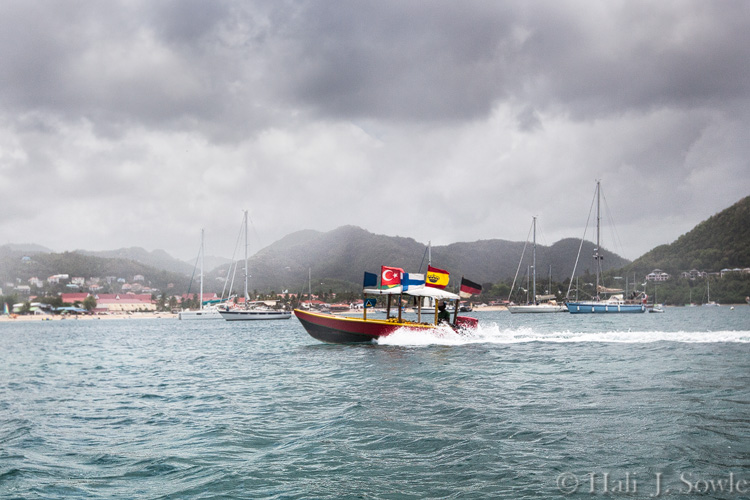 2012_03_25_SandalsLaToc-10091-Edit750.jpg - We saw this guy, or someone like him the last time we were at the Grand.  He really did have a boat full of bananas (and other fruit) and brought them around to all the beautiful boats anchored in the harbor.  This is the real banana boat!