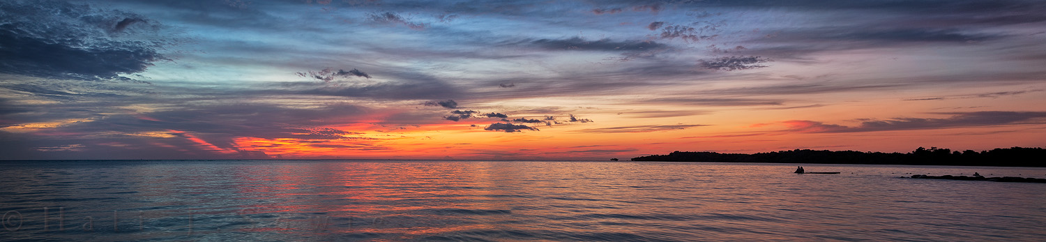 2011_11_SandalsWhitehouse-10830-33Pano.jpg - Two swimmers (on the right) watch the beautiful sunset from one of the floating platforms.