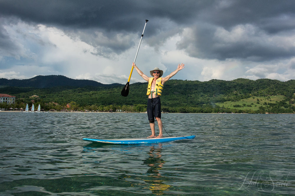 2014_09_SandalsWhitehouse-10841-Edit1000.jpg - Mike enjoying a SUP session (and hoping that he wasn't holding a lightning rod).  These poor boards were in a sad state, all banged up and the matting coming off the decking.