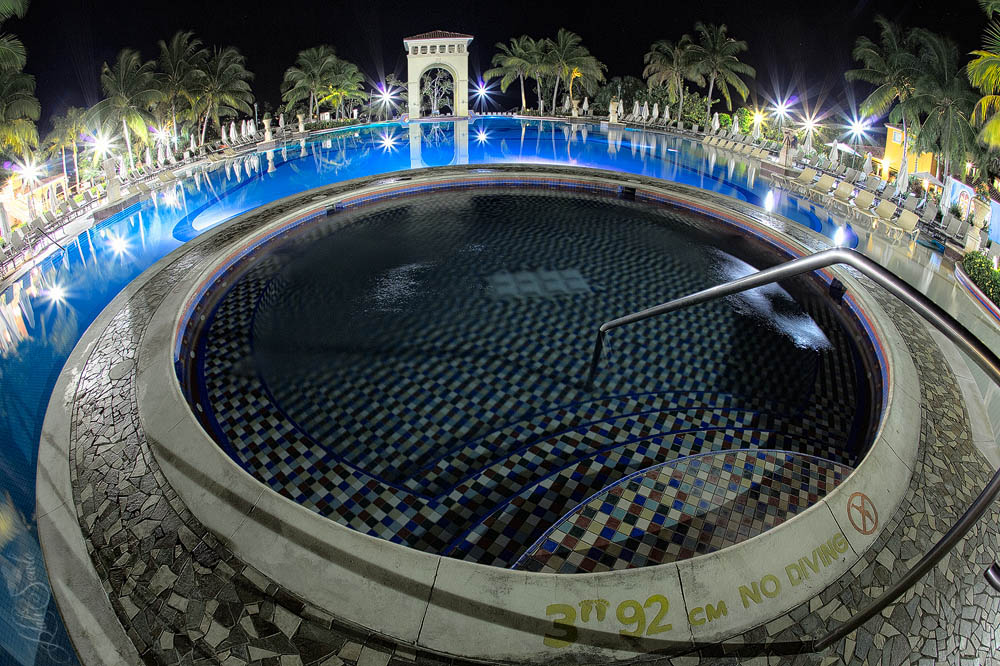 2014_09_SandalsWhitehouse-10938_Edit1000.jpg - A fisheye view of the main hot tub and pool at night.