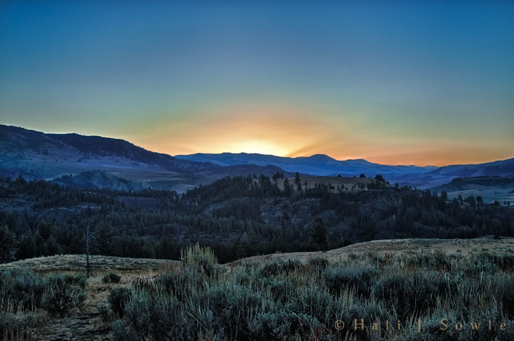 2010_09_28_Yellowstone-10001-HDR_Edit750.jpg - Just before sunrise on the road between Mammoth and Tower.  This was one of the few clear sunrises, the days after this the valleys were filled with smoke from a growing wildfire. The weather was unseasonably warm and exceptionally dry, great for fires, not so good for us.   At it's peak the fire consumed 5,510 acres before the weather finally turned cooler and wetter, by the time we left it was about 20% contained.