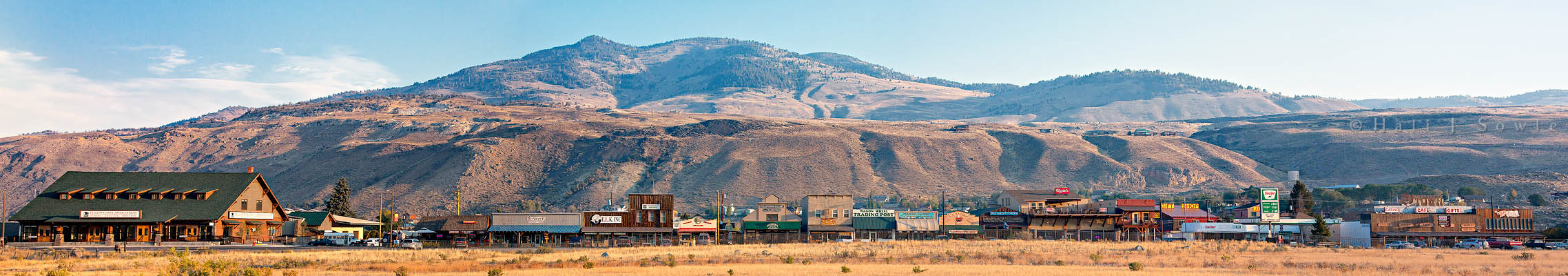 2010_10_04_Yellowstone-10015Pano-Edit750.jpg - The town of Gardiner Montana from the Yellowstone Park entrance road.  This is a panorama of 10 shots and full size is 59.5 inches by 10.5 inches, And includes all the storefronts of the town facing the park from The Yellowstone Association on the left to the Town Loft and Town Cafe on the right.  In the middle is the Yellowstone Perk, home to a great iced latte, and incredible homemade raspberry and white chocolate scones.