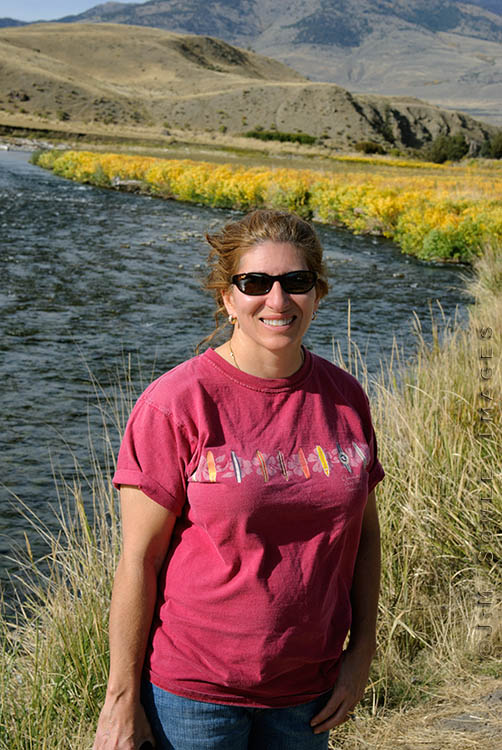 _JMS0046_A.jpg - The weather was unusually mild during our visit.  Hali was plenty warm in a T-shirt as she was taking shots of the Gardener river.  This part of the park (the North entrance) extends up into Montana.