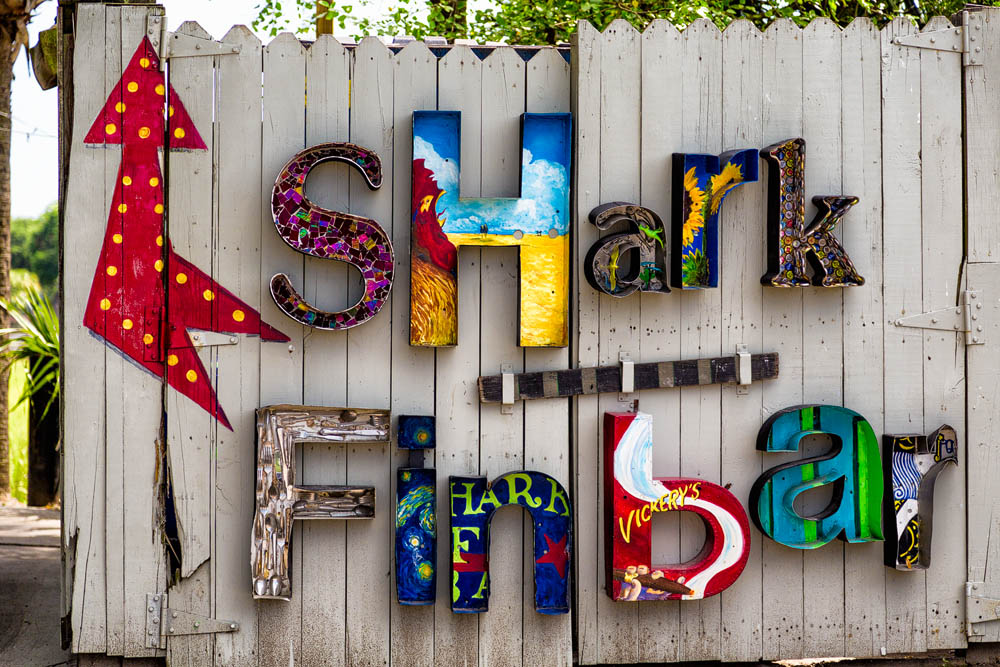 2016_06_Savannah_Charleston-11732-Edit1000.jpg - We spent a day out exploring the islands to the north and east of Charleston, Sullivans Island and Isle of Palms.  At the end of the day as we were driving back to Charleston we stopped at Shems Creek Park.  The shrimp boats come in and out along the river there and dock to unload the days catch.  The big restaurant there was Vickery's and the out door bar was the Shark Fin Bar out along the water.  This sign was a great way to disguise the dumpster.